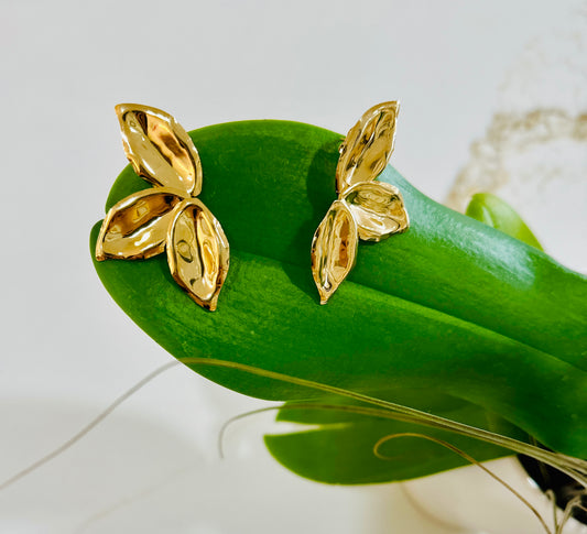 Petals - plated 18k gols hammered gold earrings shaped like flower petals.